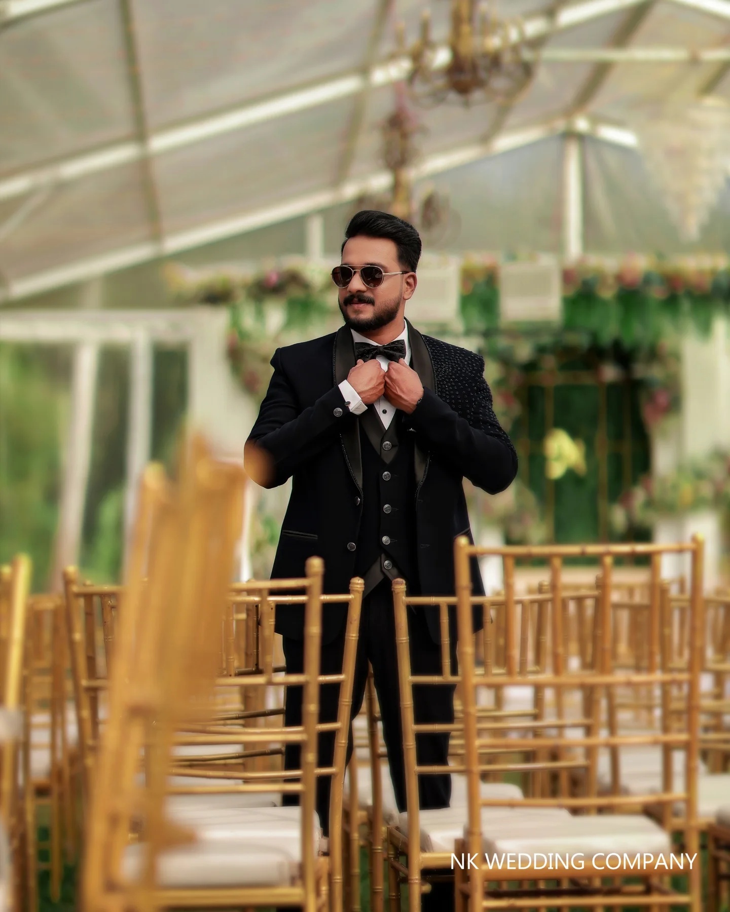 Groom adjusting his tuxedo at the reception